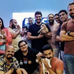 employees playing with puppies